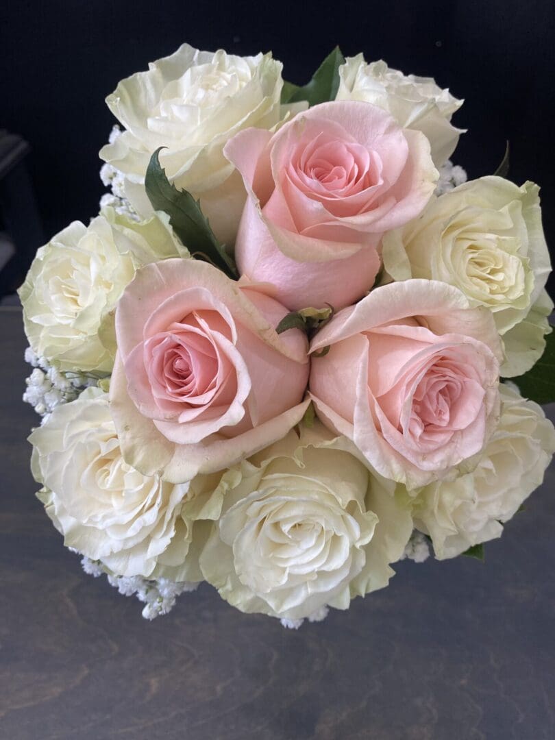A bundle of light pink and white roses