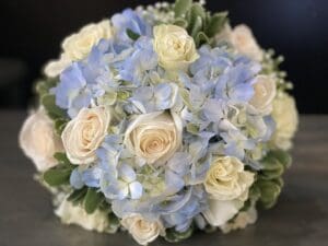 A bundle of powder blue and white roses