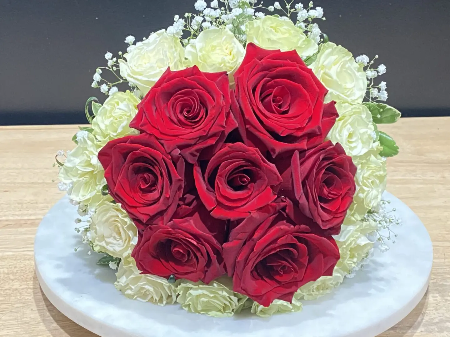 A bundle of white and red roses