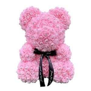 A pink rose bear with diamonds and a black ribbon