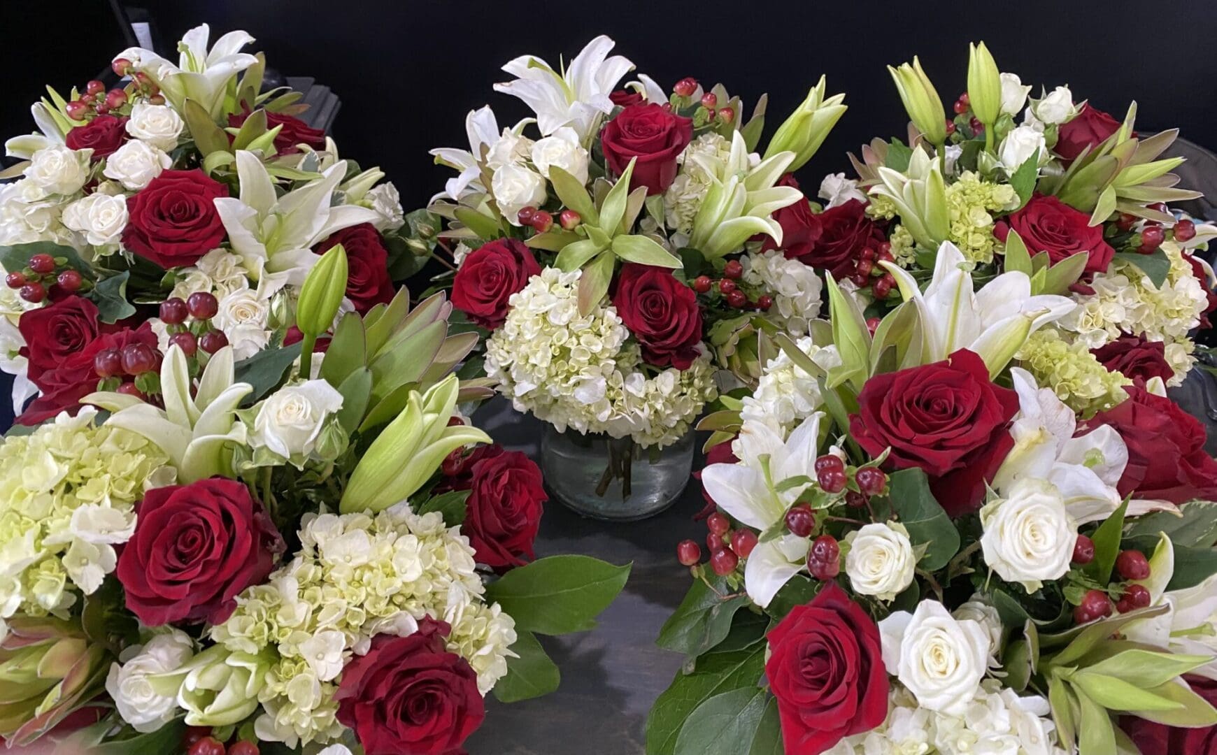 Vases full of red roses and white lilies