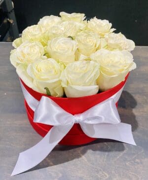Red box of white roses with bow.
