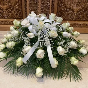 A white ribbon over a bundle of white roses