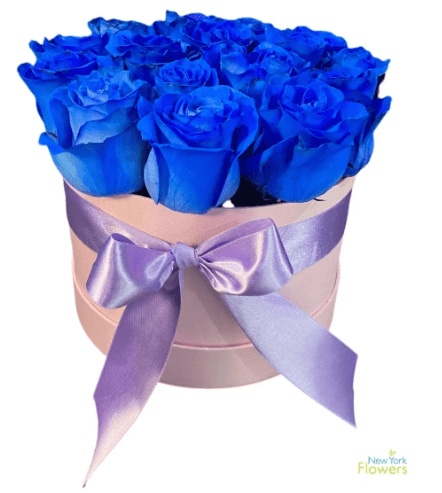 A pink gift box with blue roses and a purple ribbon