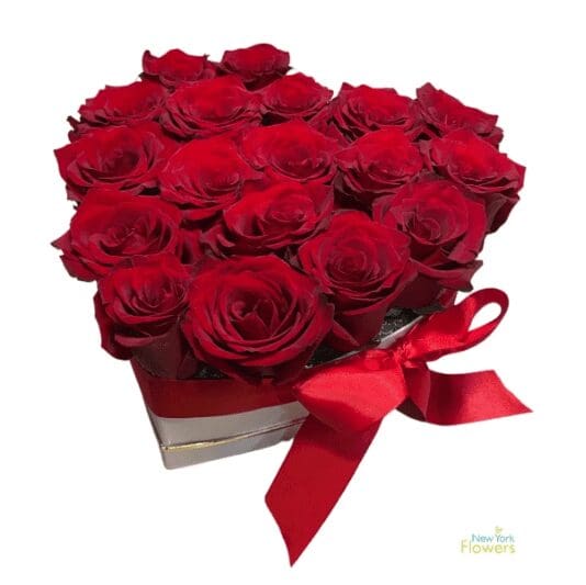 A heart-shaped gift box with red roses and a ribbon