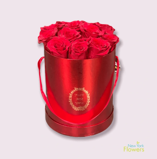 A red gift bucket with red roses and a red ribbon