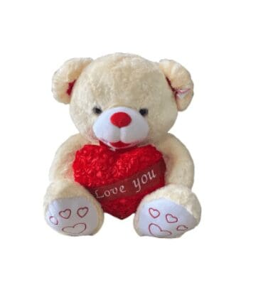 A white bear plushie holding a heart made of roses