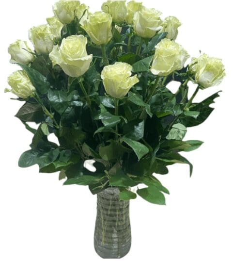 A glass vase with white roses