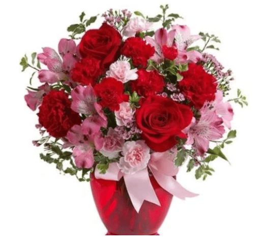 Pink and red flowers in a red glass vase