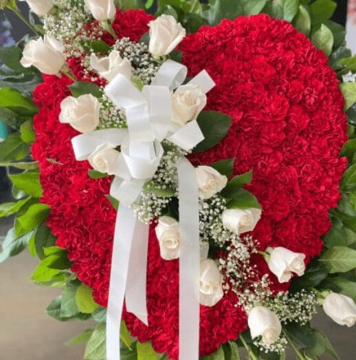 A red heart-shaped floral wreath
