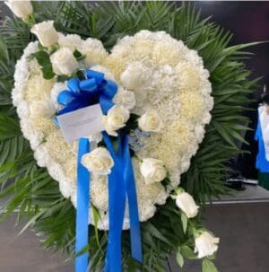 A white heart-shaped floral wreath