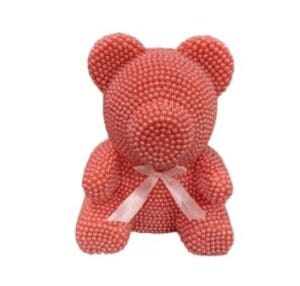 A bear made of pink beads and a ribbon