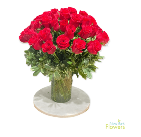 A glass vase with red roses