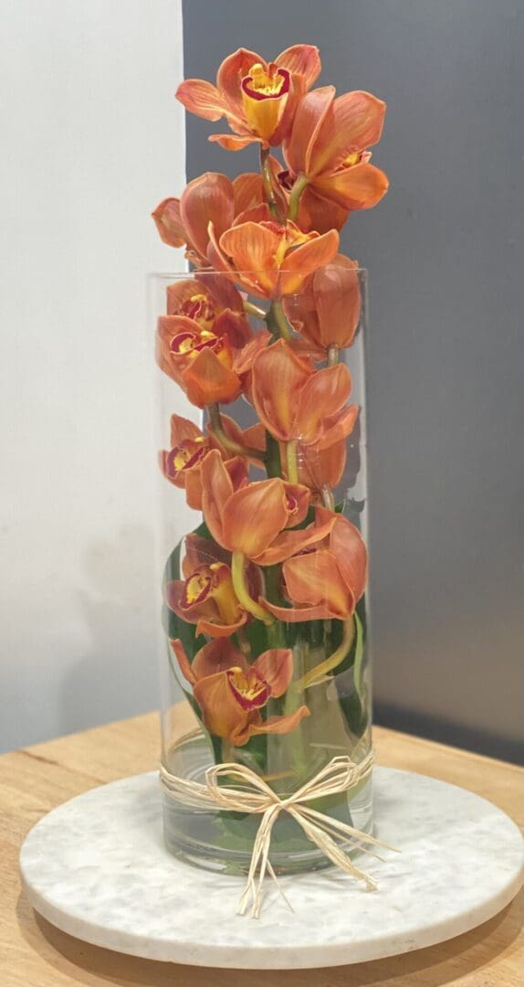 A vase full of orange orchids