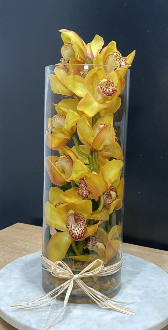 A vase with yellow orchids