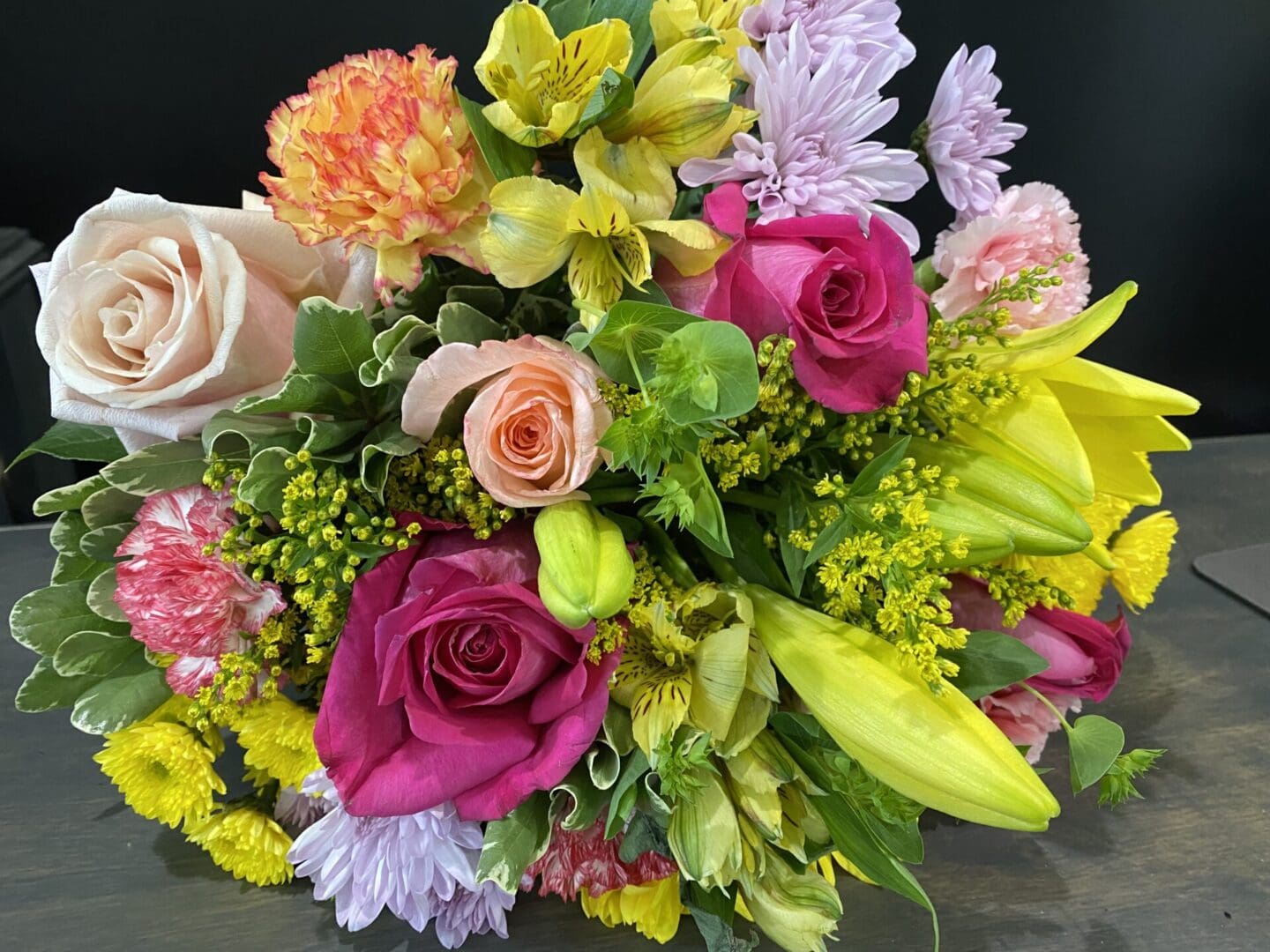 A bouquet of yellow, pink, and purple flowers