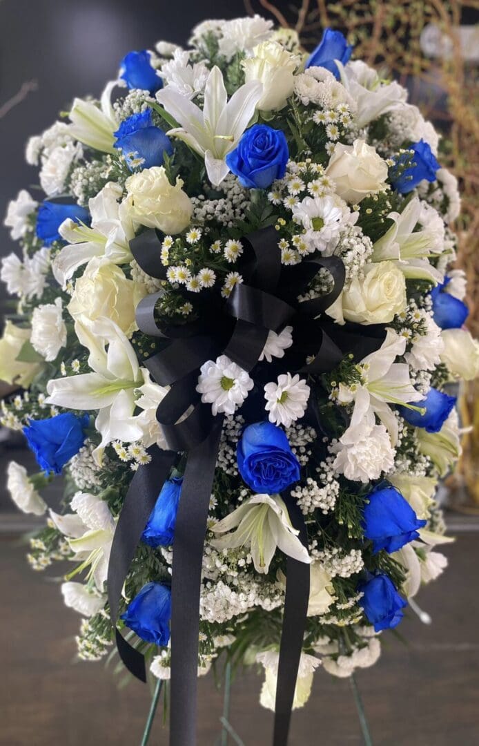 White and blue flowers wrapped in a blue ribbon
