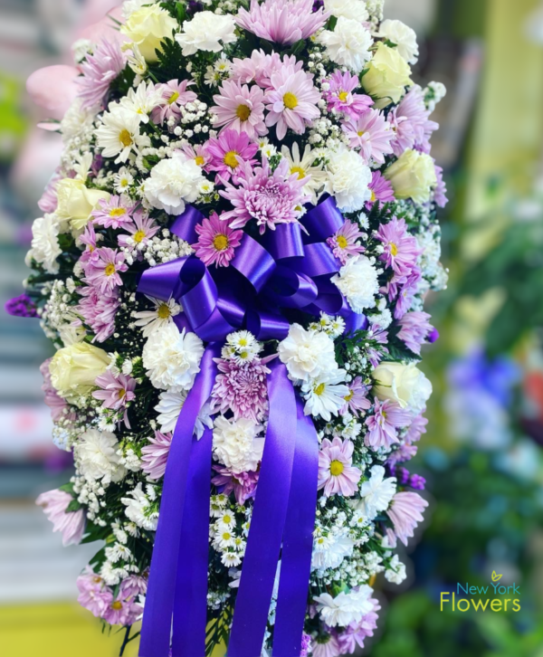 Purple and white flowers wrapped in a blue ribbon