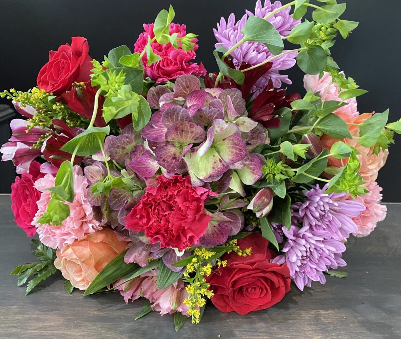 A bundle of purple and pink flowers of different types