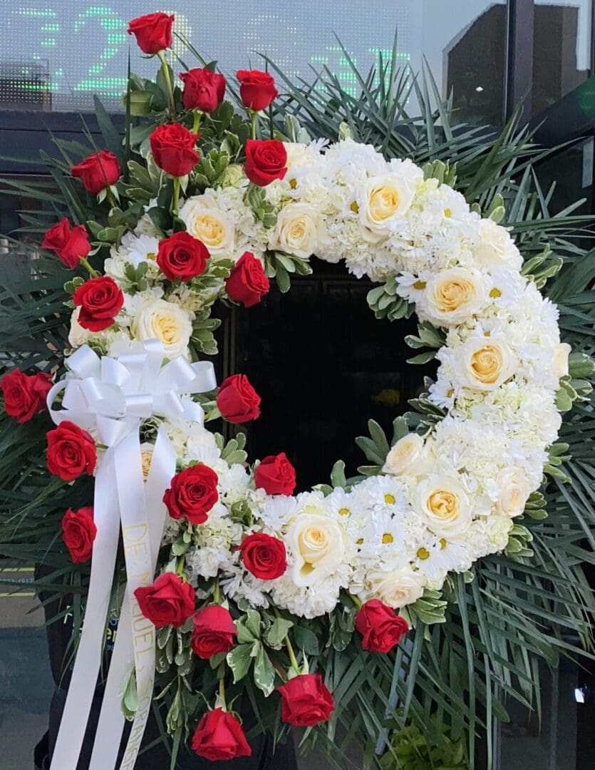 A wreath made of white and red roses