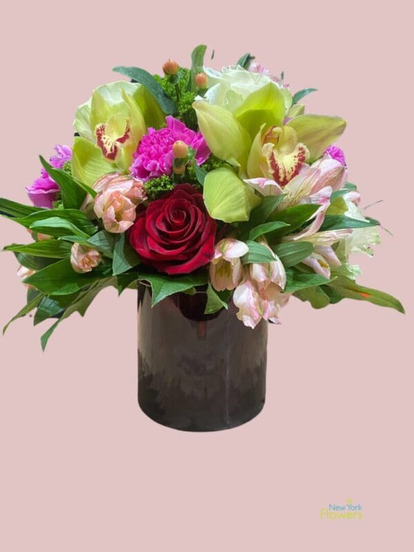 A black gift box with assorted pink flowers