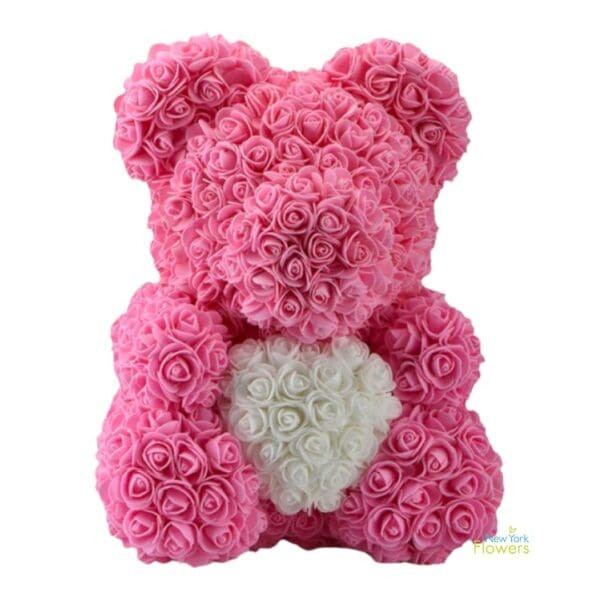 A pink rose bear with a white heart