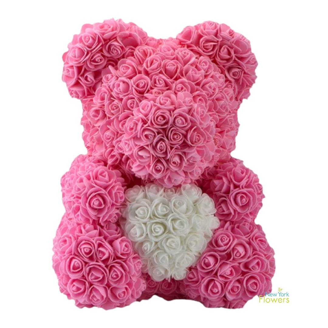 A pink rose bear with a white heart