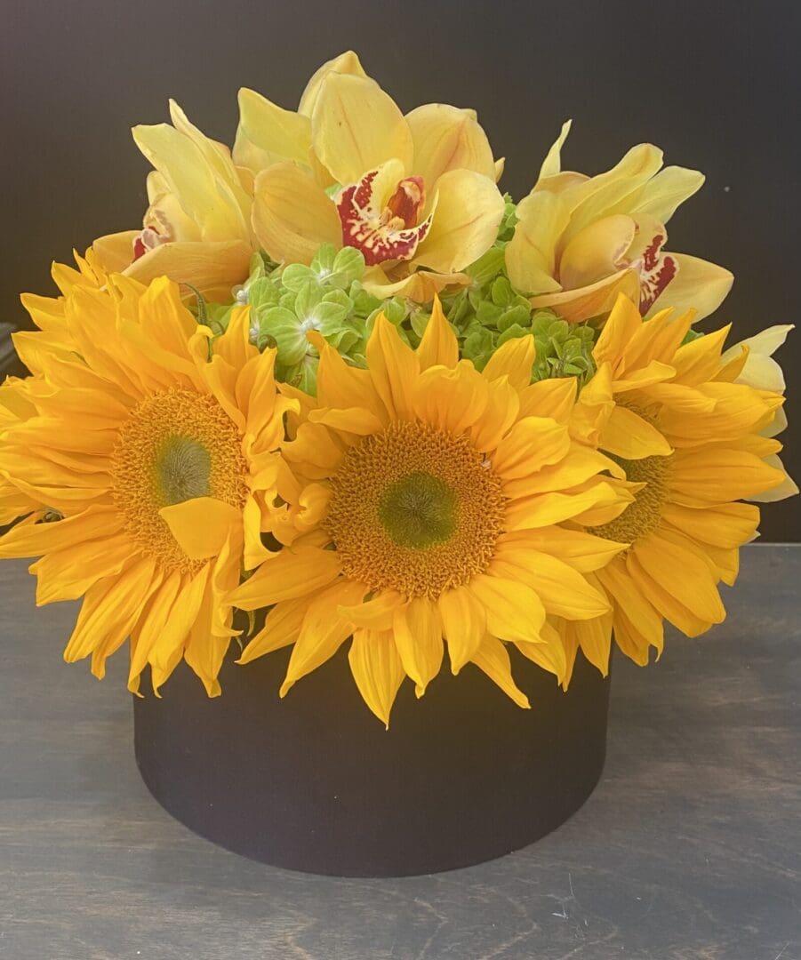 A black gift box with yellow flowers