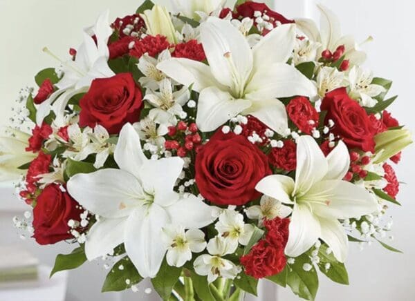 A bundle of white lilies and red roses
