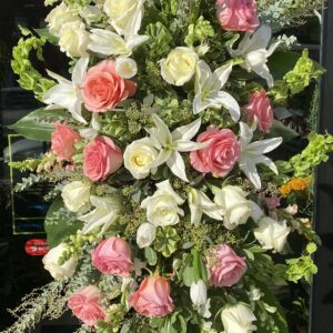 A stand with white and pink roses