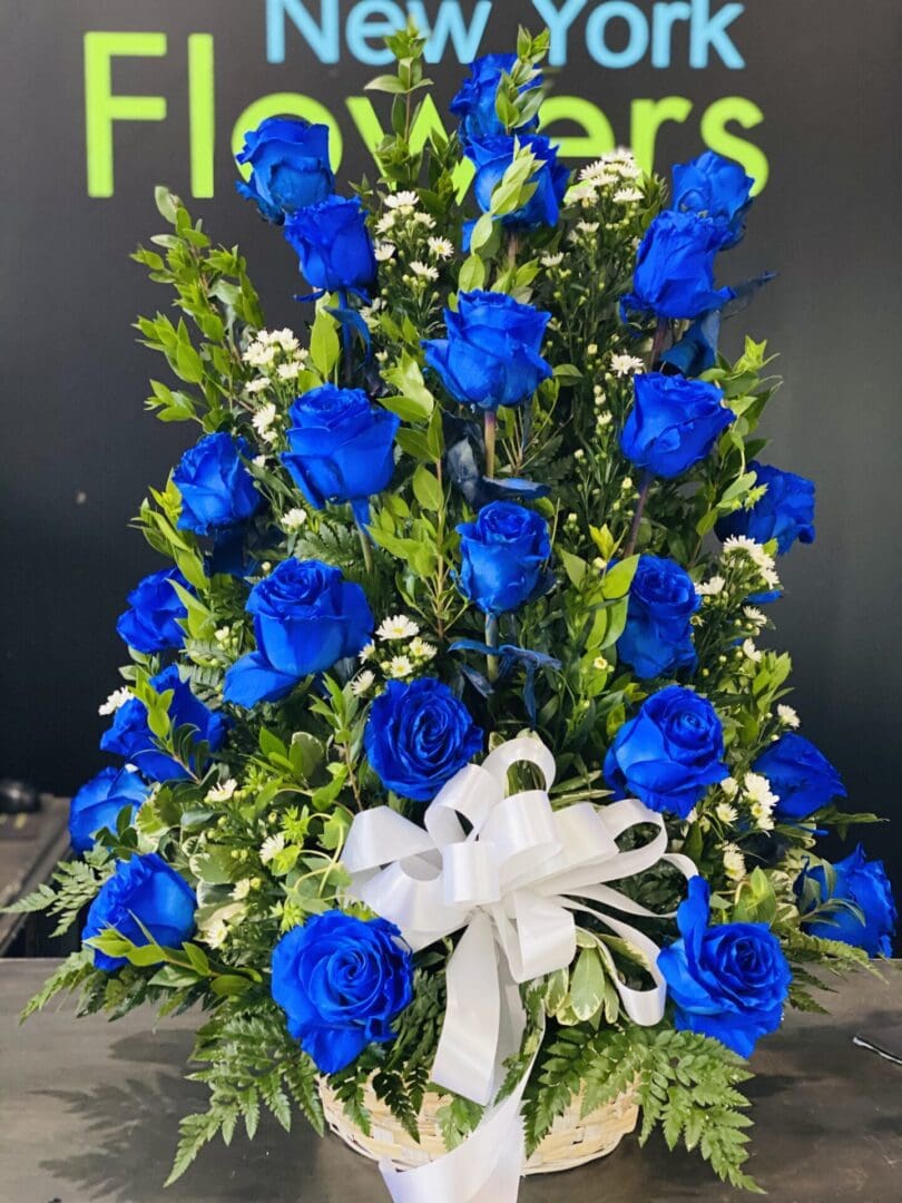 Blue roses wrapped in a white ribbon