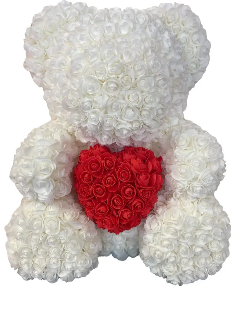 A white rose bear with a red heart