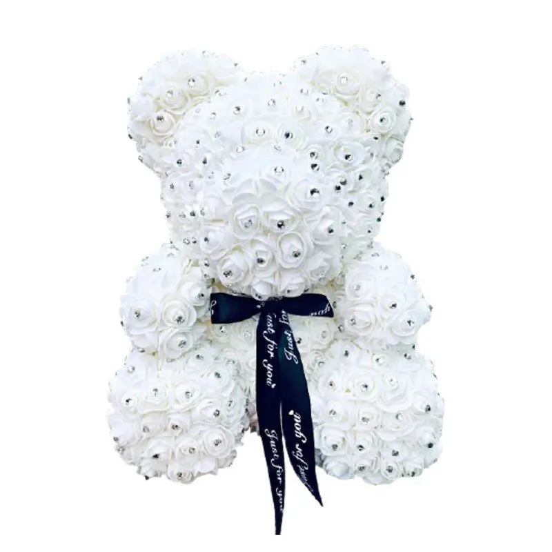 A white rose bear with diamonds and a black ribbon