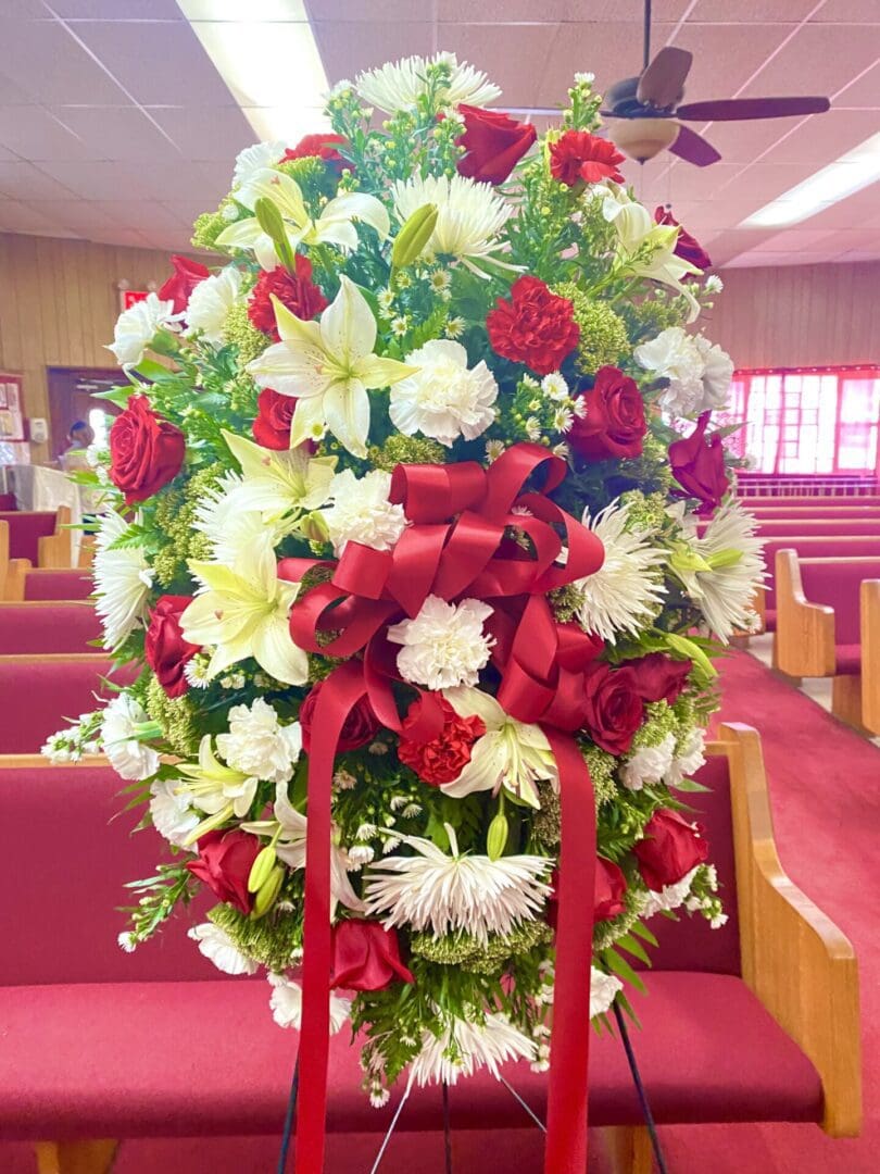 A stand with maroon and white flowers