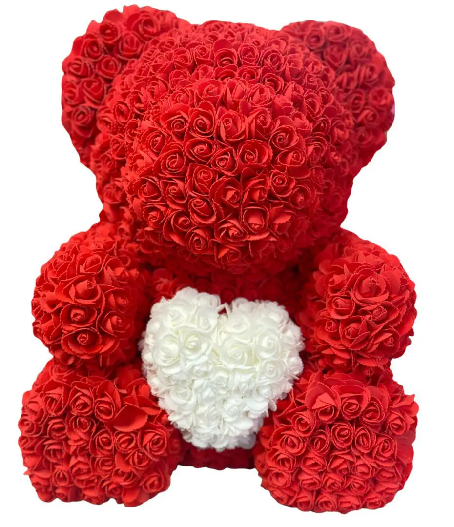A red rose bear with a white heart