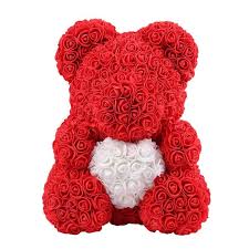 A red rose bear with a white heart