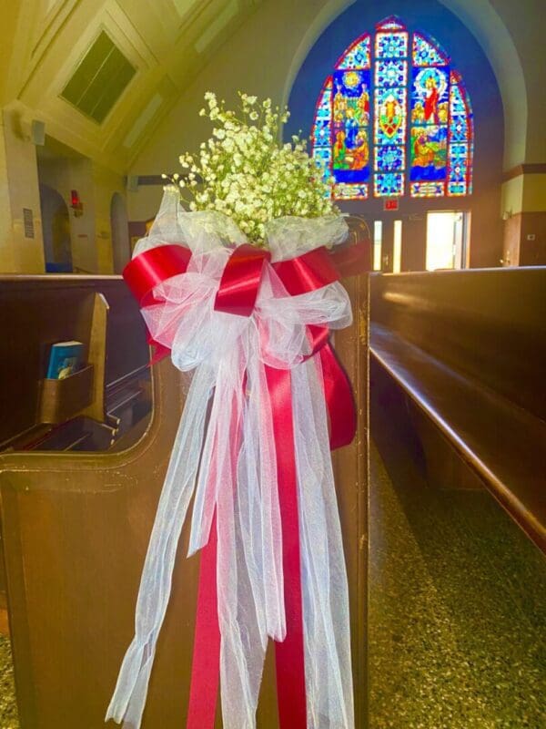 Tulle Bows with a touch of Baby Breath on Pews