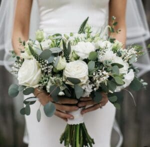 A Bride Holding Beautiful White Roses