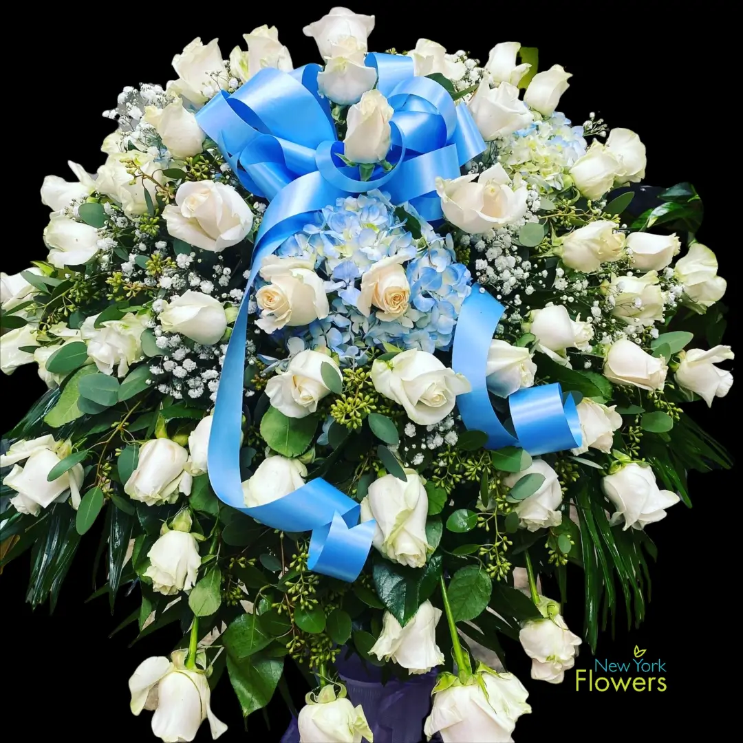 Blue and White Casket Spray with blue ribbon