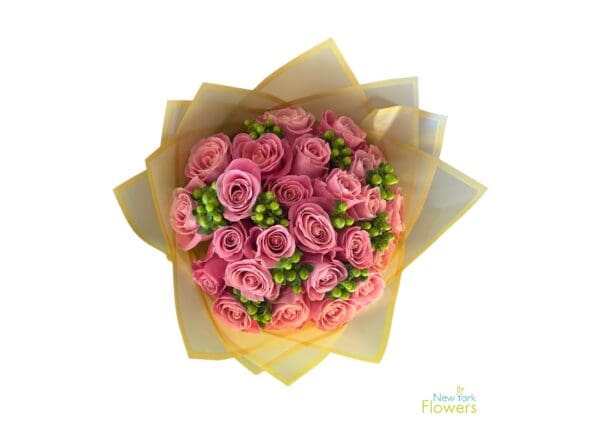 A bouquet of Pink Hermosa roses accented with greenery and wrapped in yellow paper, presented by New York Flowers.