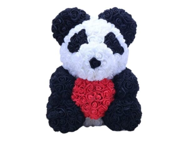 Panda rose bear with a red heart in flowers