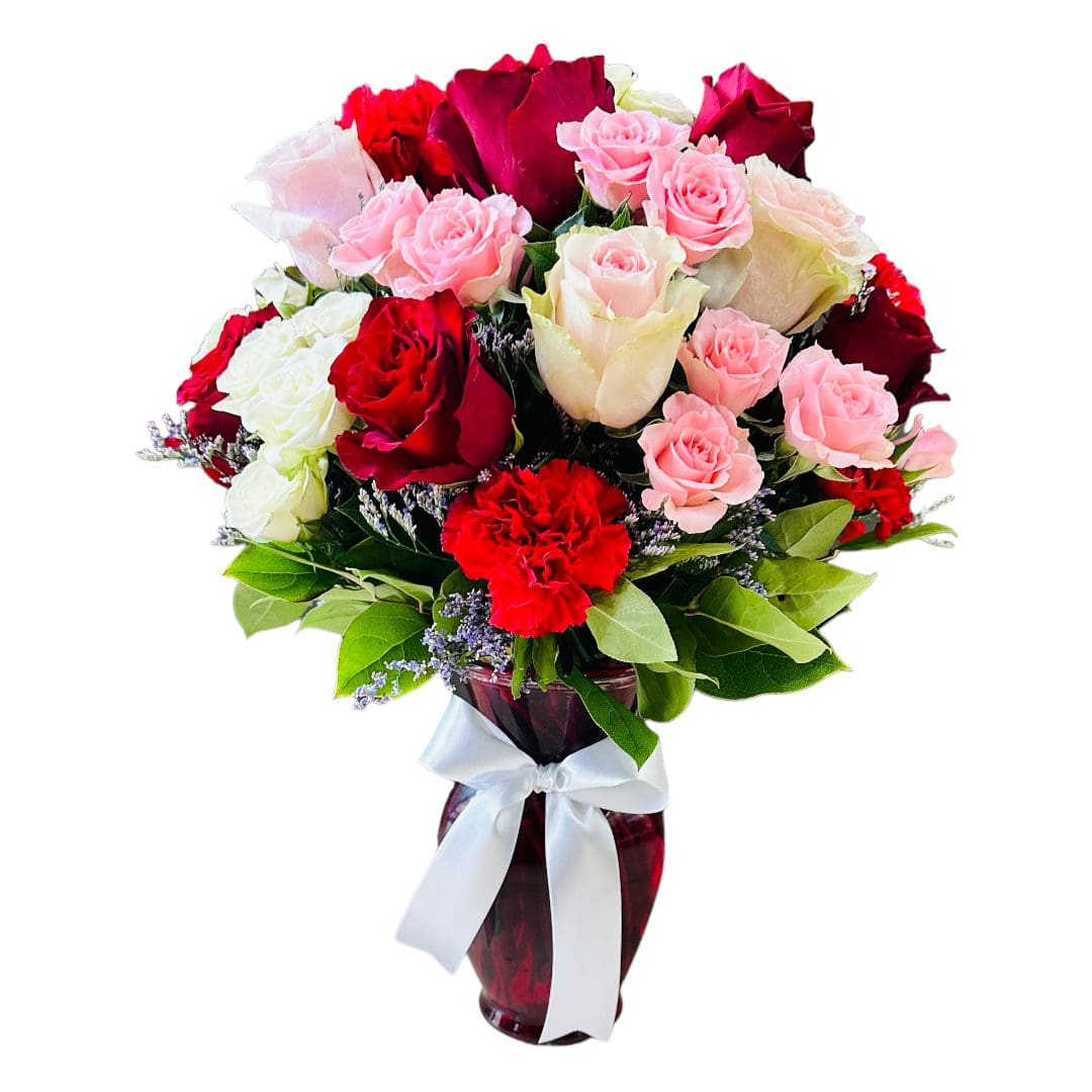 A bouquet of mixed roses in various shades of pink, red, and white, accented with small purple flowers and green leaves.