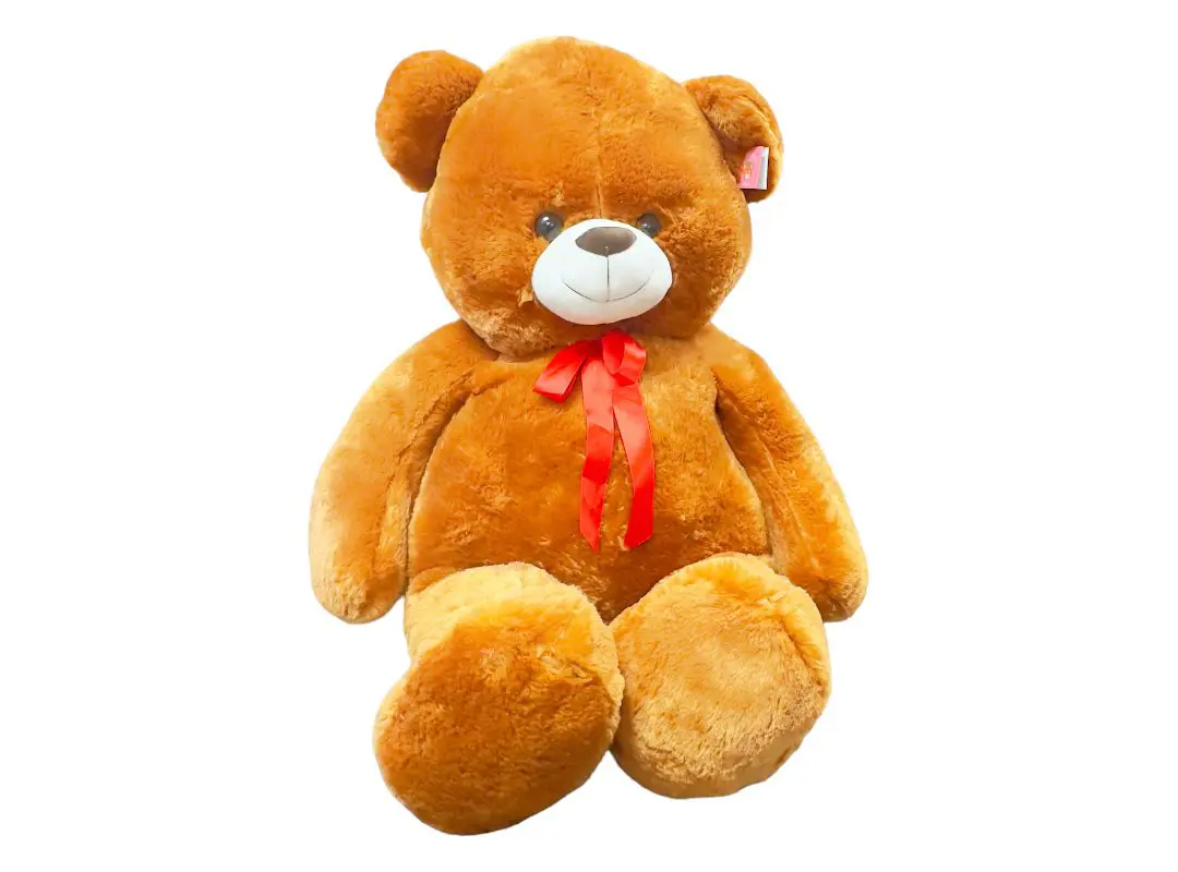A plush brown teddy bear with a red bow around its neck, isolated on a white background.