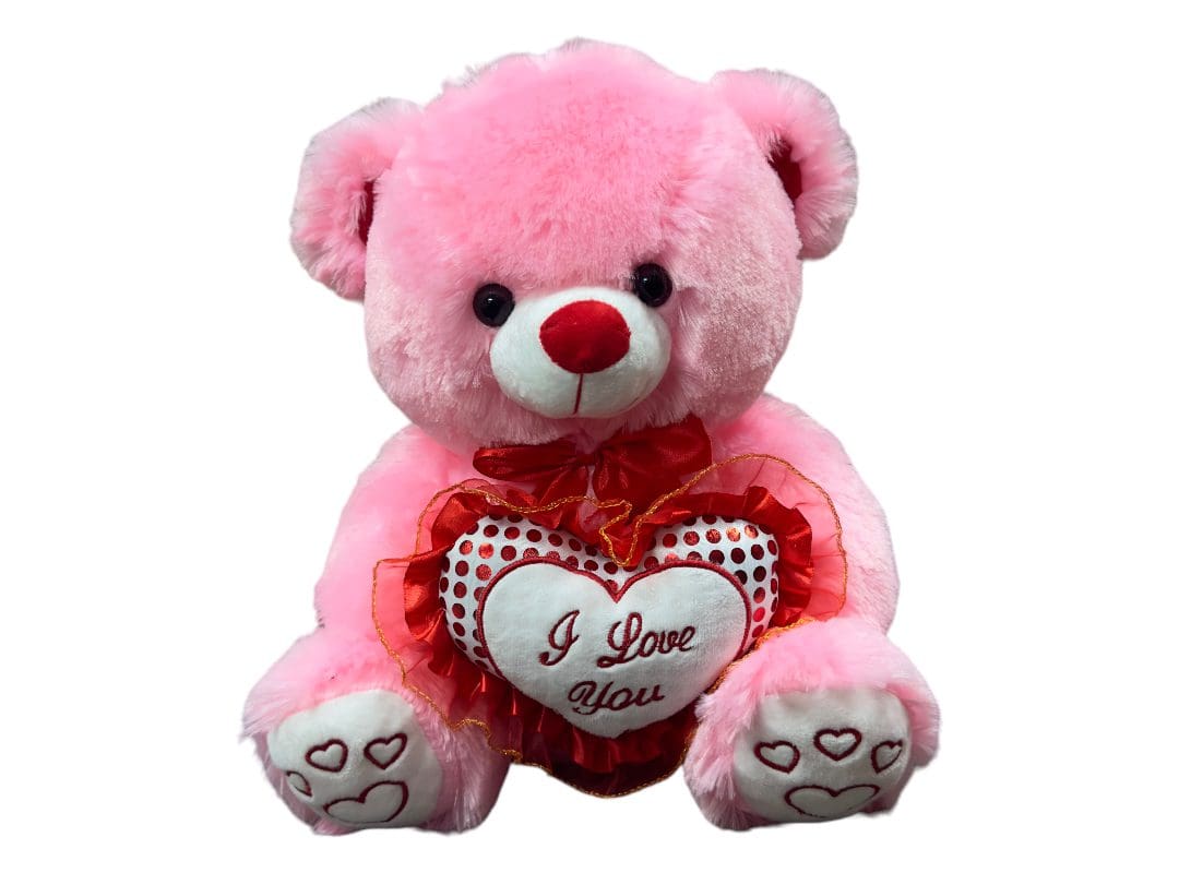 Pink teddy bear holding a heart that says "i love you" against a white background.