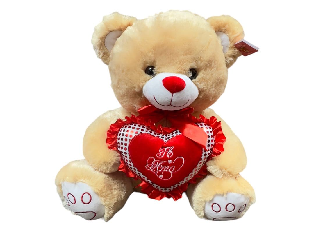 Plush teddy bear holding a red heart with the words "i love you" embroidered on it.