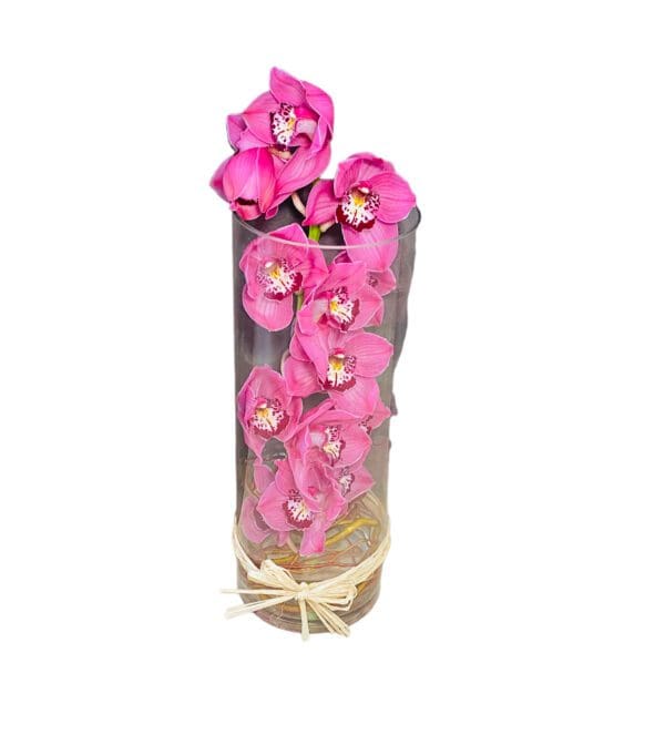 Bouquet of pink orchids in a clear cylindrical vase.