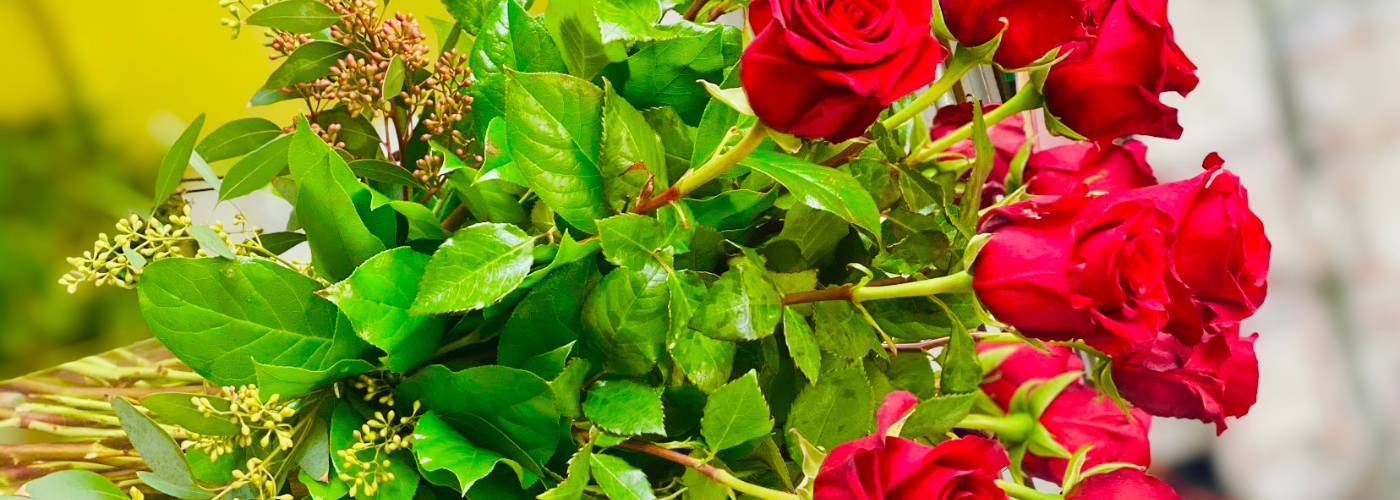 A vibrant bouquet of roses with green foliage.