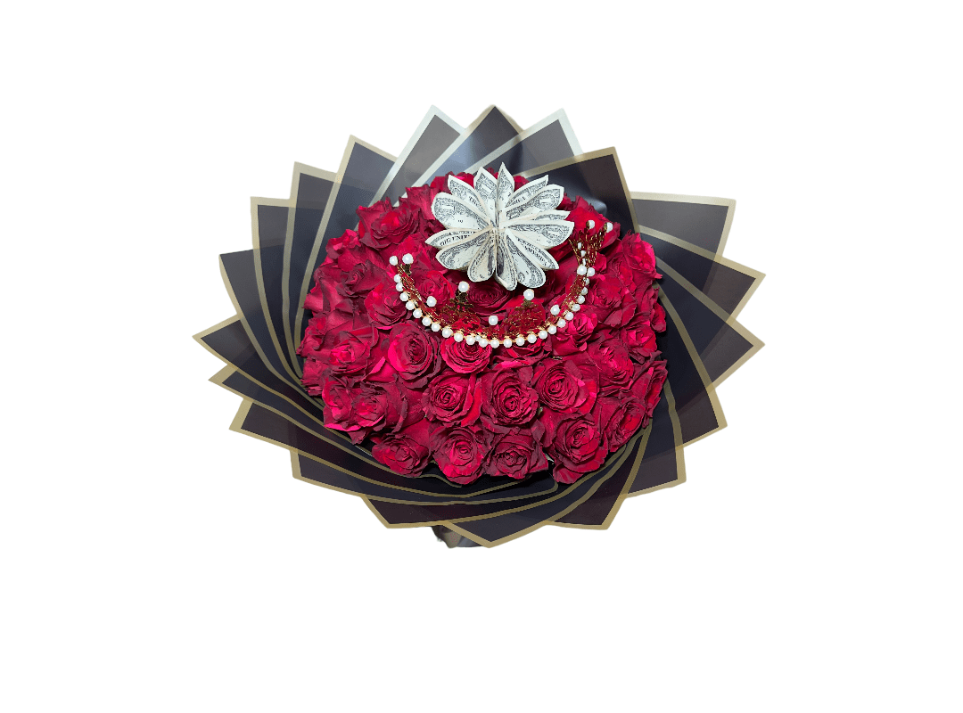 An ornate bouquet of red roses adorned with a silver brooch, presented on a layered backdrop of dark and metallic petals.
