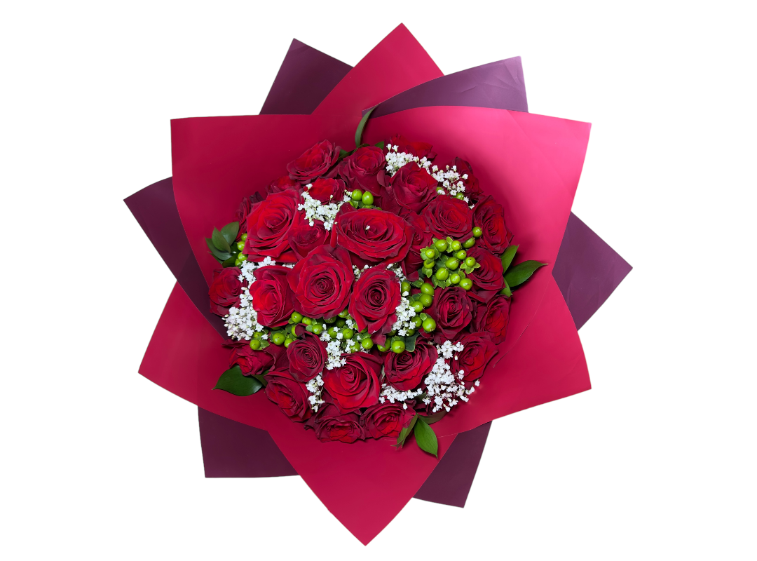 Bouquet of red roses with baby's breath and greenery wrapped in deep red paper.