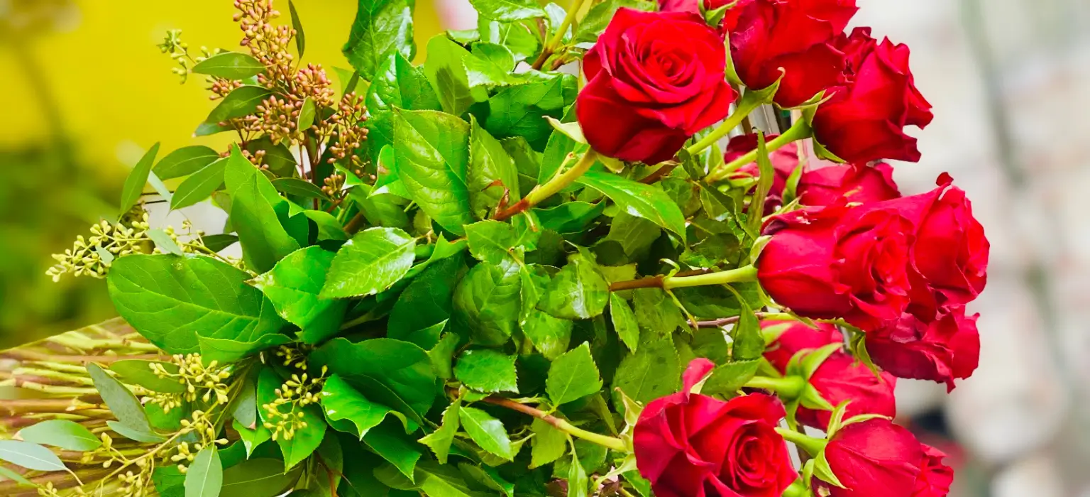 Red roses and greenery bouquet.